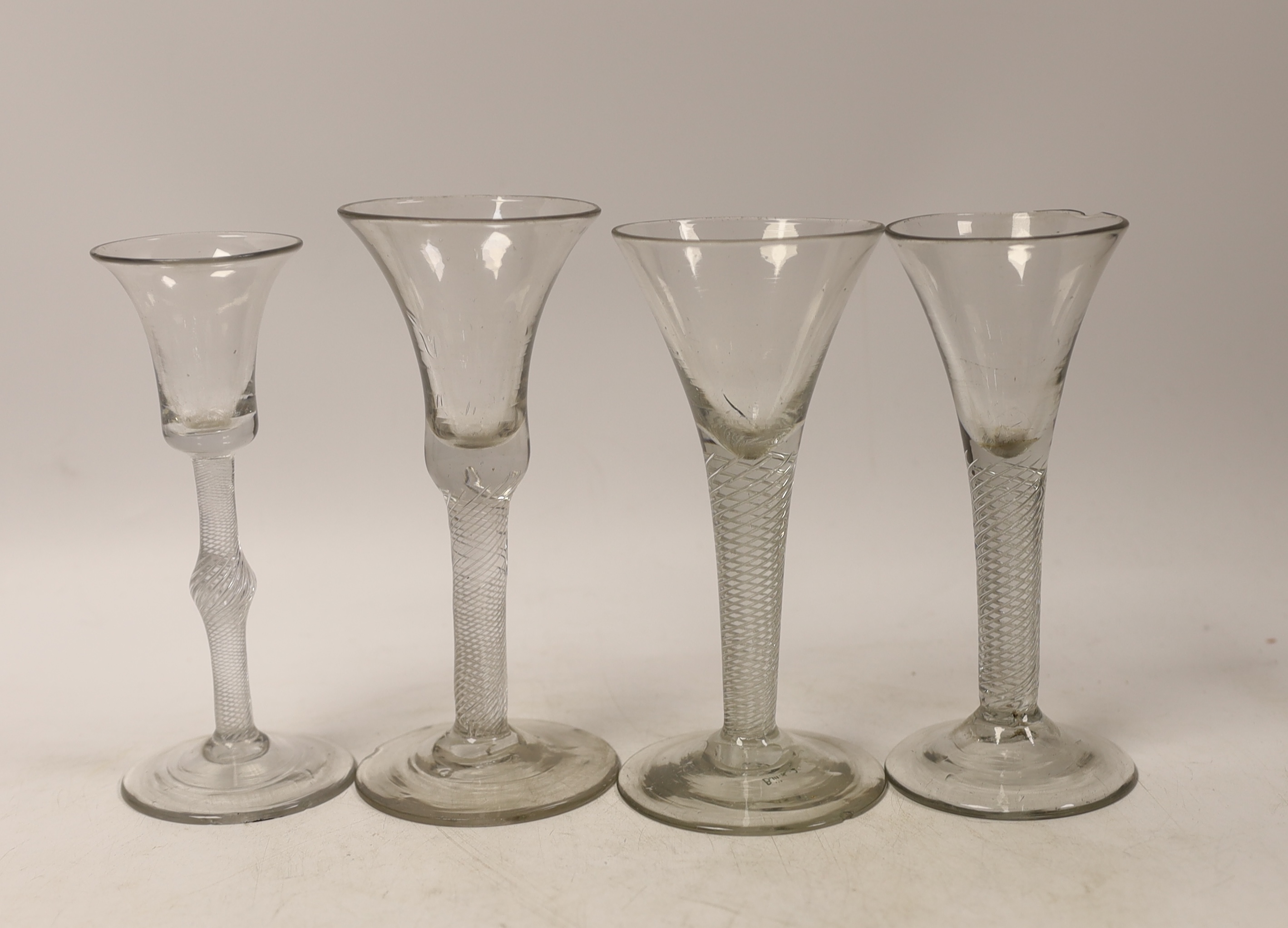 Four mid-18th century DSAT stem wine glasses, two drawn trumpet examples and two with bell shaped bowls, tallest 15.5cm